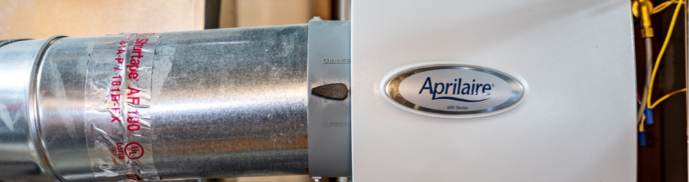 A newly installed whole home humidifier connected to a residential furnace.